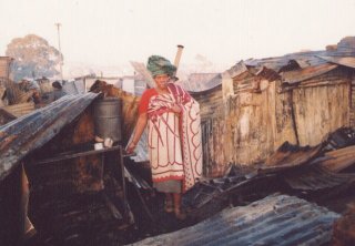 Nofenishala Khonjo amid the wreckage of what was once her home